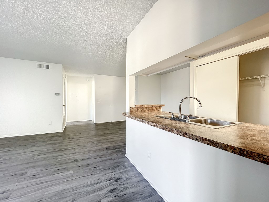 a kitchen with a sink and a mirror