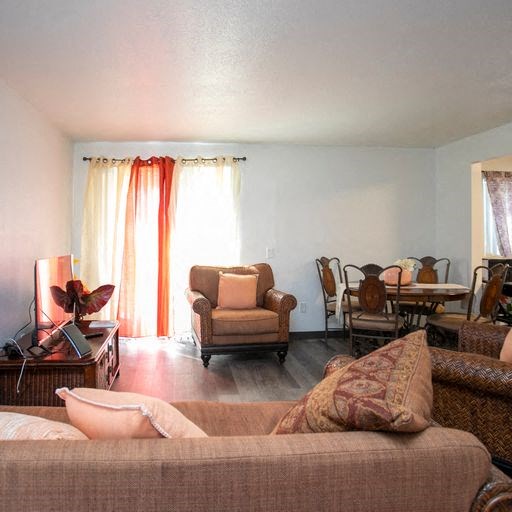 a living room with a couch and chairs and a table