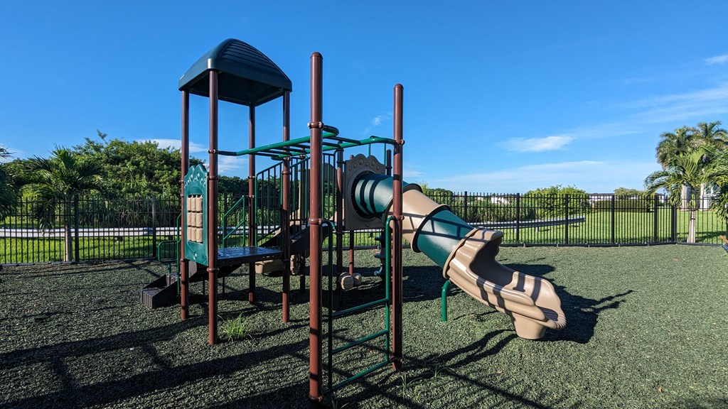 a slide and monkey bars in a playground at a park
