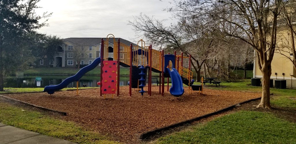 a playground in a park in front of a building