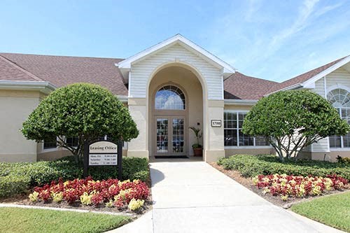 a large house with a sidewalk in front of it