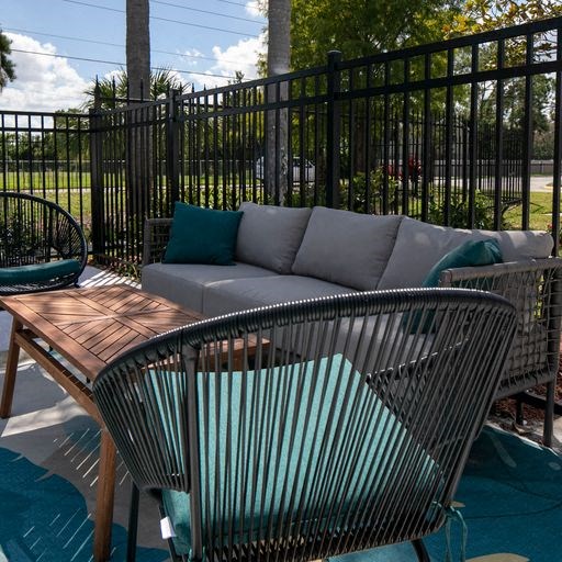 a patio with a couch and a table and chairs