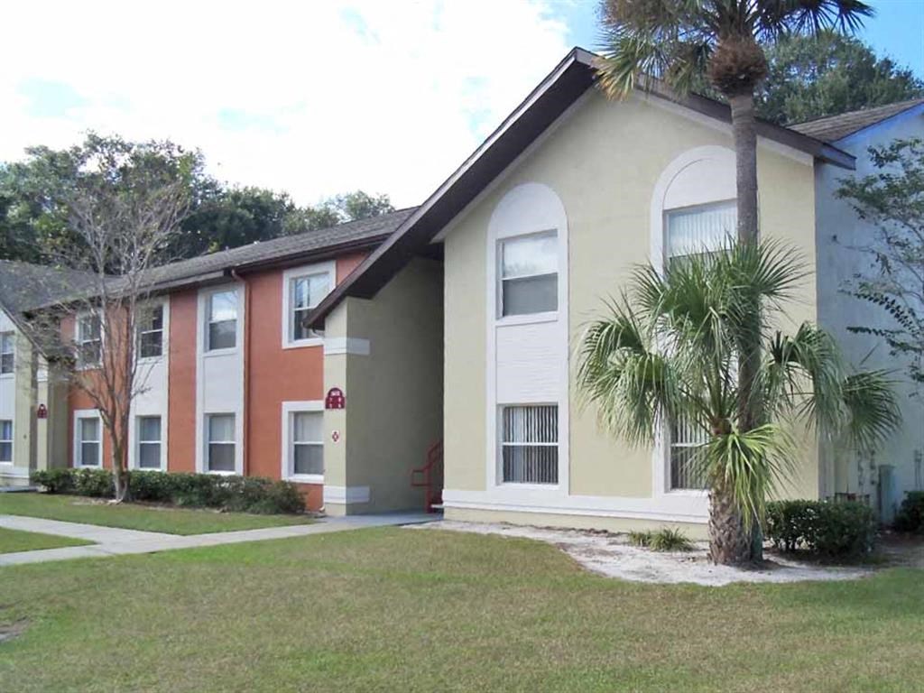 a building with a palm tree in front of it