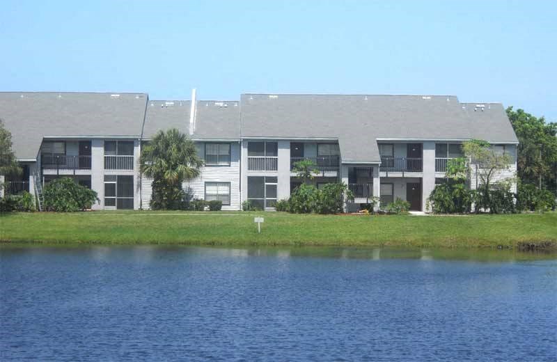 an apartment building next to a body of water