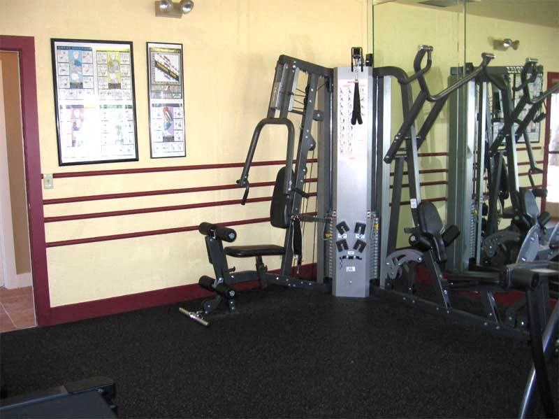 a gym with weights and other equipment in it