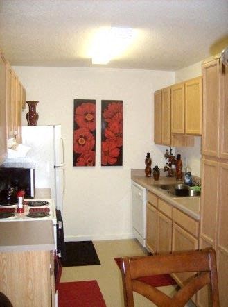 a kitchen with a sink and a refrigerator