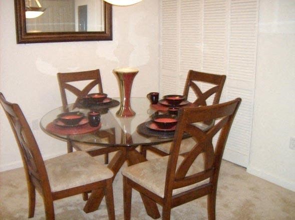 a dining room table with four chairs