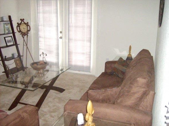 a living room with a couch and a glass table
