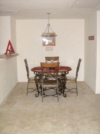 a dining room with a table and chairs