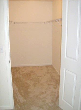 an empty room with a white wall and a door