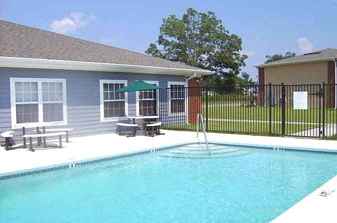 a large swimming pool in front of a house