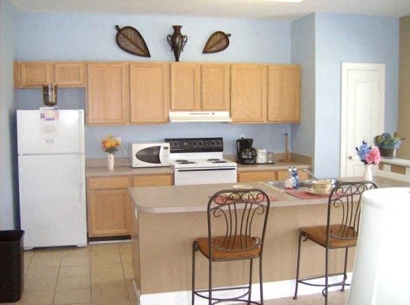 a kitchen with wooden cabinets and a white refrigerator