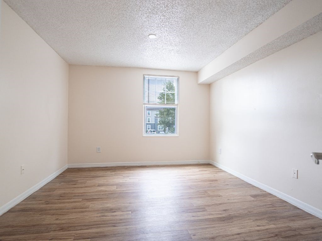 a room with pink and white walls and a window