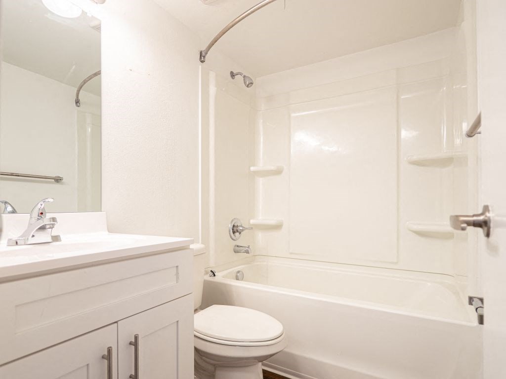 a bathroom with a sink toilet and a bath tub