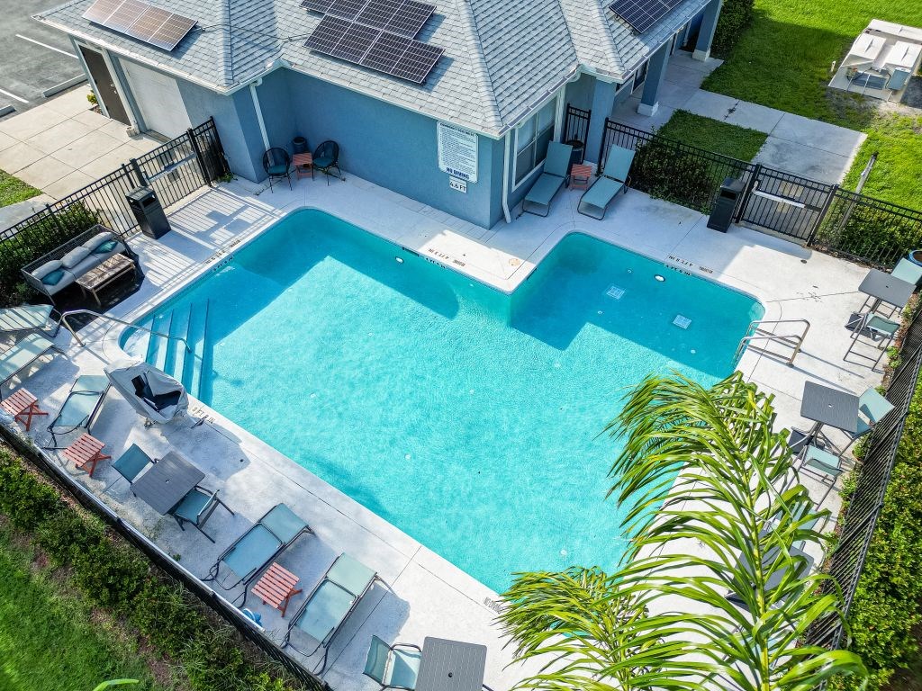 a large swimming pool in front of a house with a pool