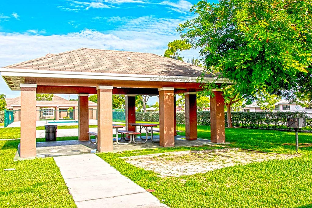 a pavilion with a picnic table in a park