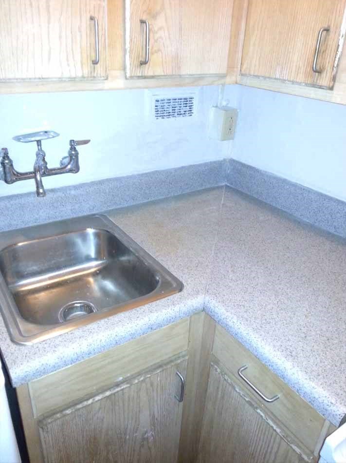 a kitchen with a sink and a counter top