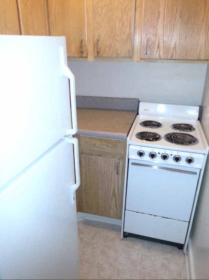 a kitchen with a stove and a refrigerator