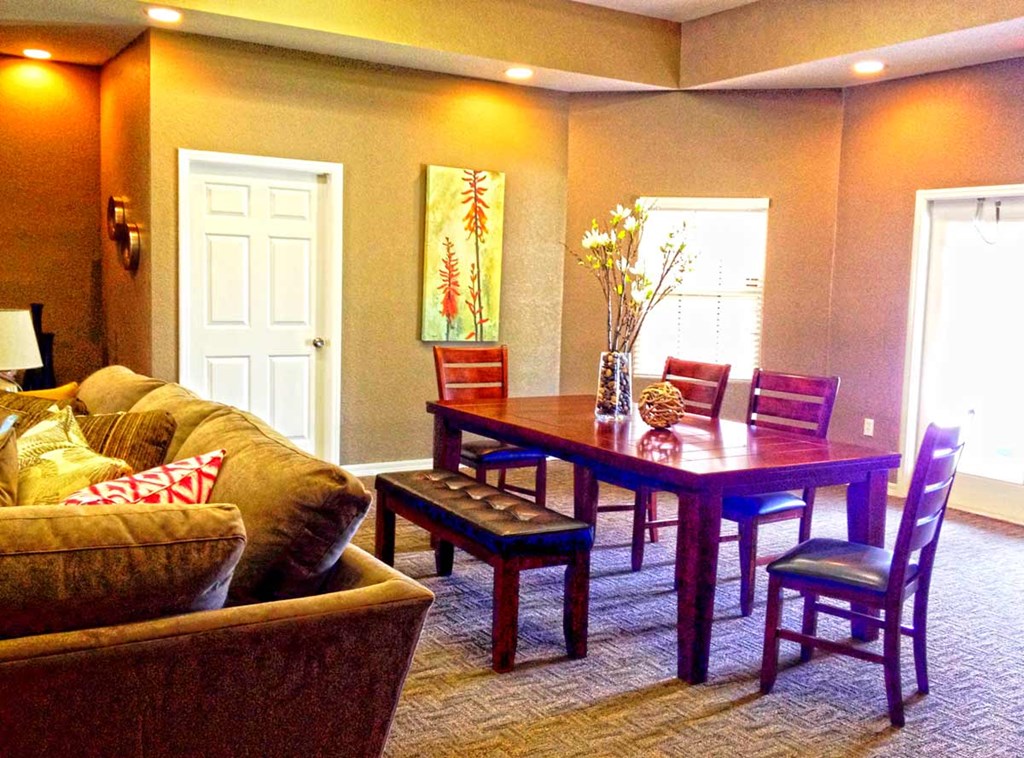 a living room with a dining table and a couch