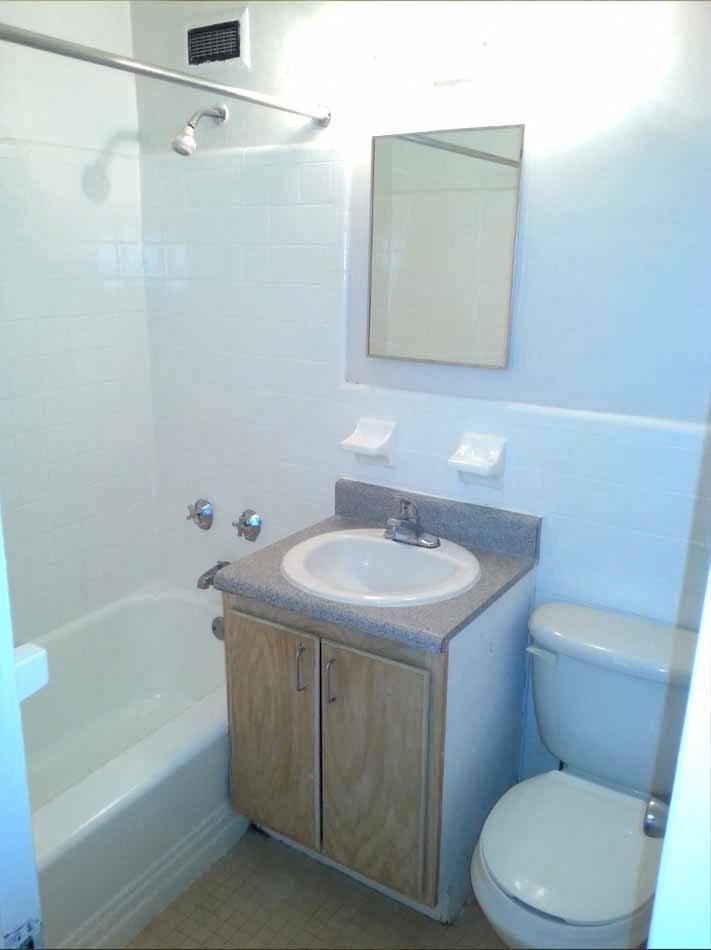 a bathroom with a toilet and a sink and a bath tub