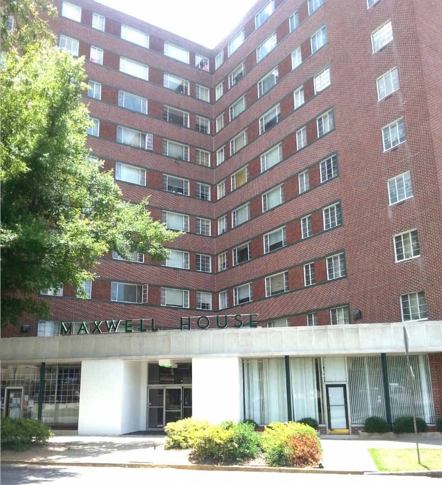 a large brick building with a sign that reads navy house