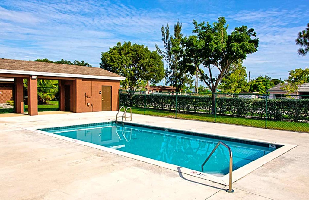 a swimming pool in a backyard with a building