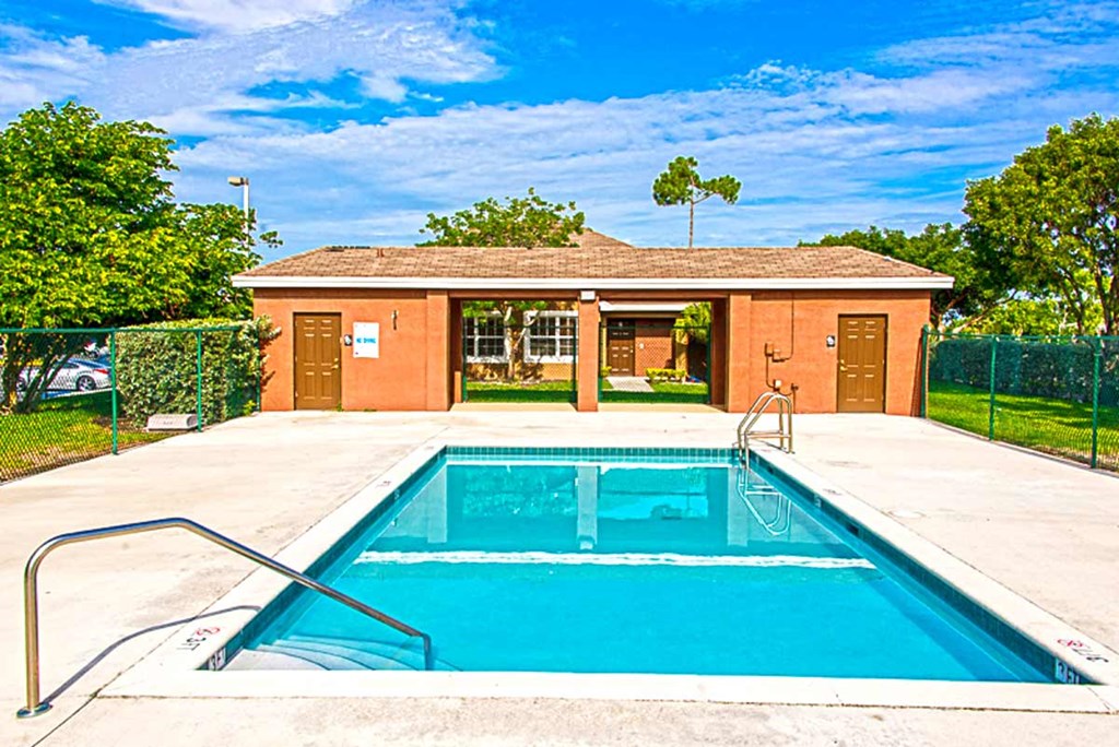 a swimming pool with a house in the background