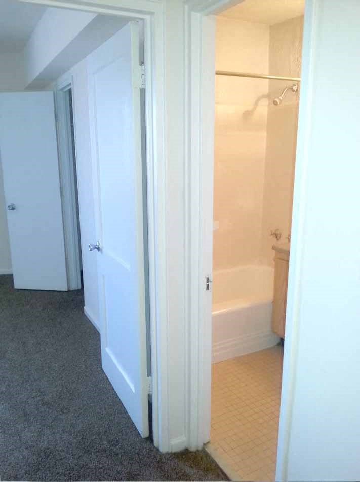 a bathroom with a bath tub and a closet