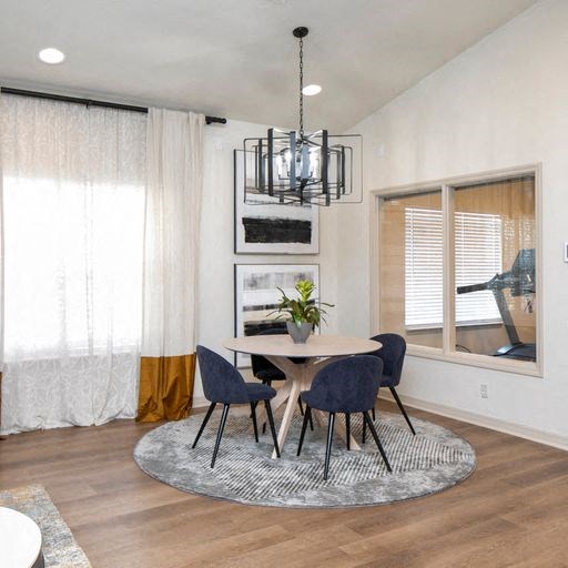 a dining room with a table and chairs