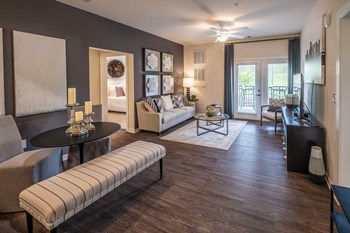 Living Room With Oversized Windows And Doors Living Room With Oversized Windows And Doors at Abberly CenterPointe Apartment Homes by HHHunt, Virginia