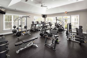 a gym with weights and cardio equipment at Abberly Green Apartment Homes by HHHunt, Mooresville, NC
