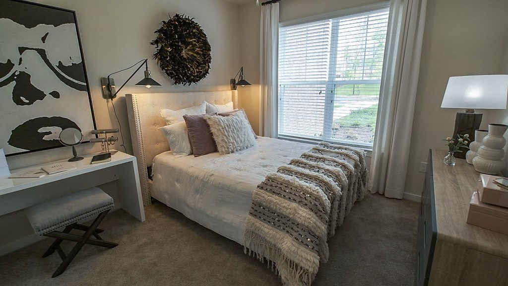 Cozy bed in bedroom with window at Abberly CenterPointe Apartment Homes, Midlothian