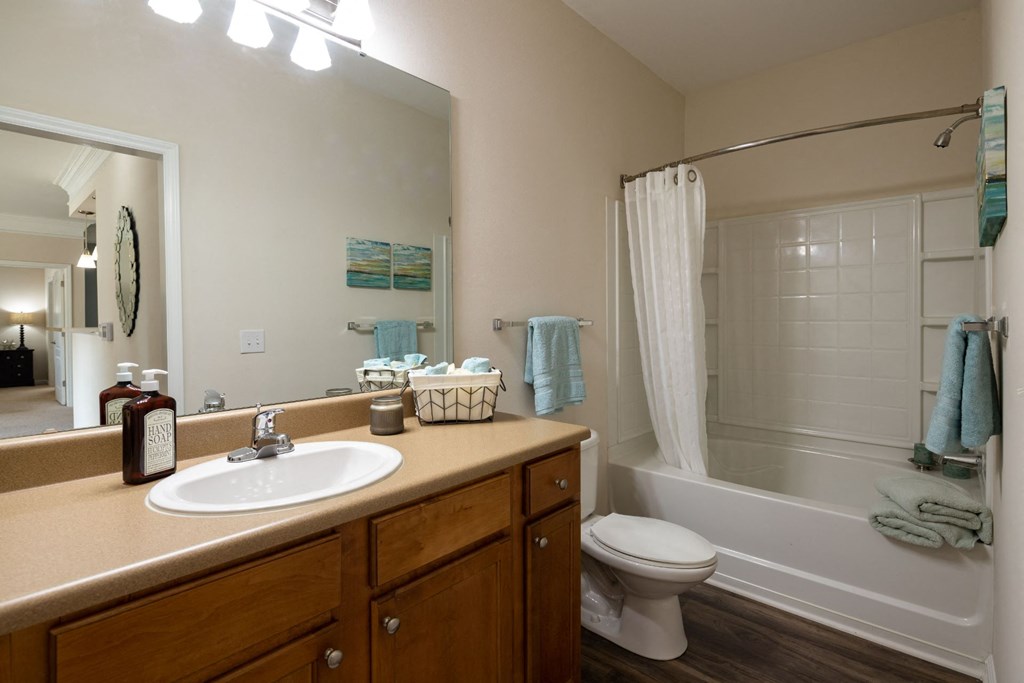 Large Soaking Tub In Master Bathroom With A Tile Surround at Abberly Place at White Oak Crossing Apartments, HHHunt Corporation, Garner, NC