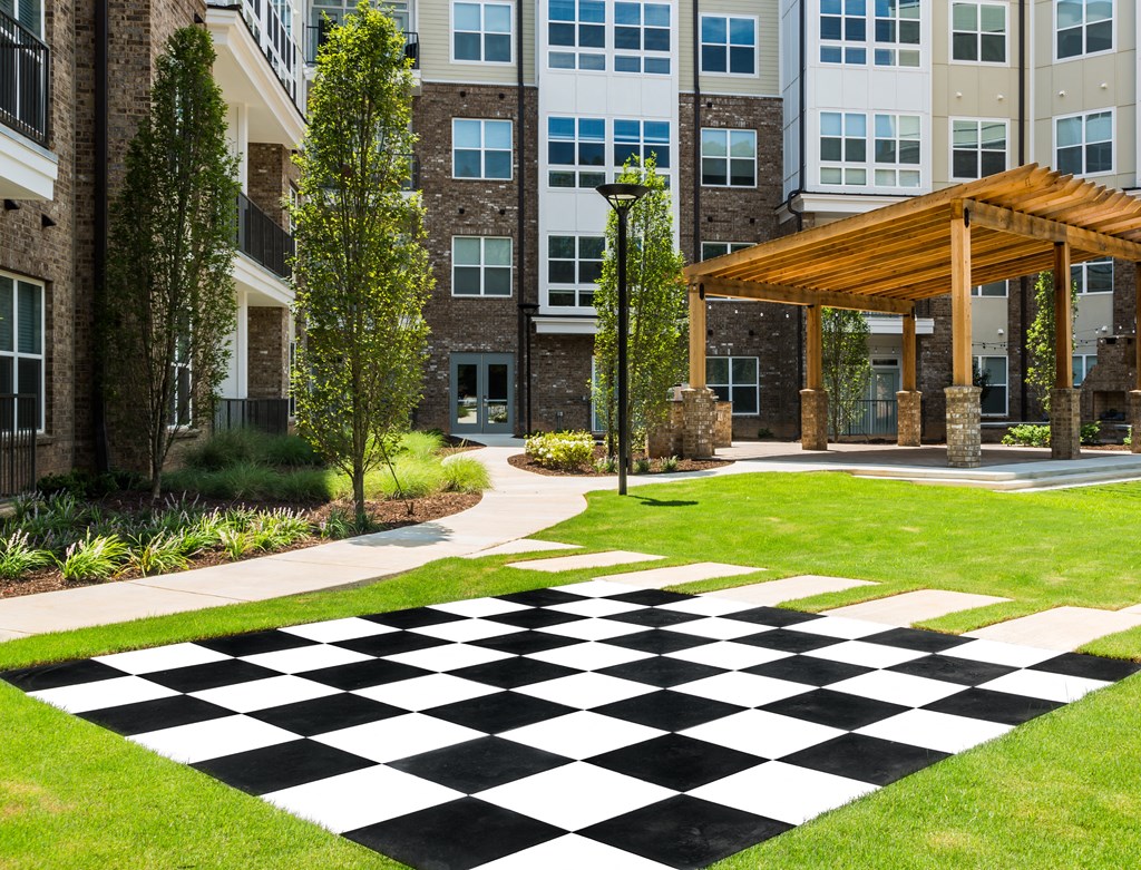 a black and white checkered sidewalk in front of an apartment building
