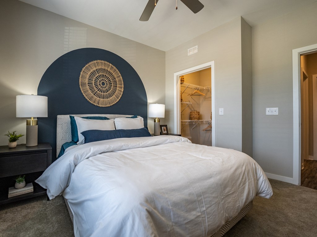 a bedroom with a large bed and a ceiling fan