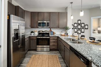 a kitchen with stainless steel appliances and granite countertops