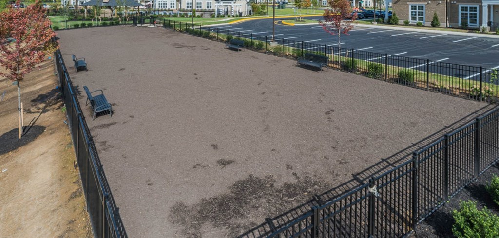 a parking lot with a fence and benches