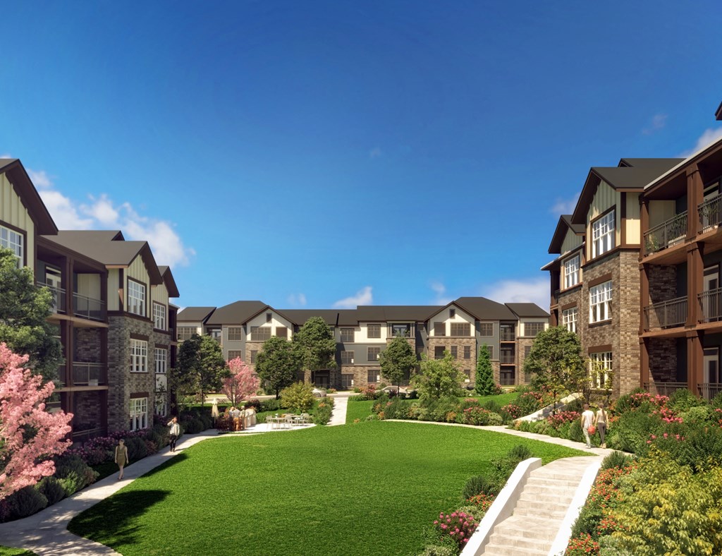 a rendering of an apartment complex with a green lawn