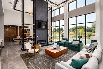 a large living room with a fireplace and large windows