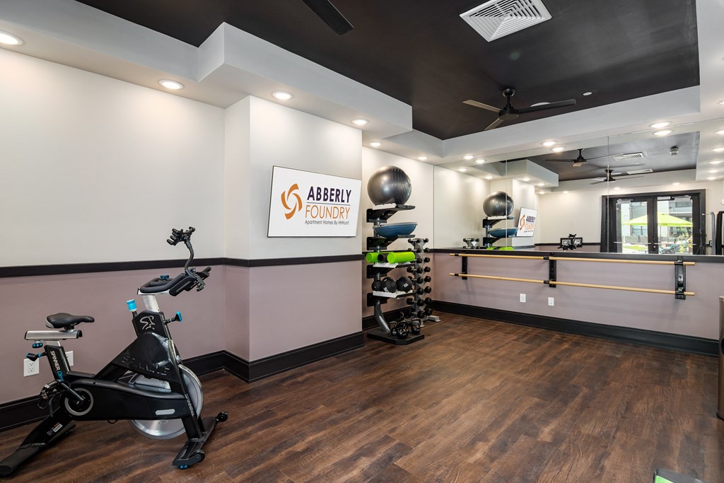 a gym with exercise equipment and a counter with a sink at Abberly Foundry Apartment Homes, Nashville, 37203