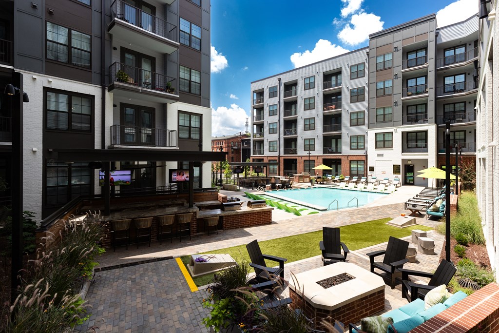 an outdoor lounge area with lounge chairs and a fire pit at the bradley braddock  at Abberly Foundry Apartment Homes, Nashville