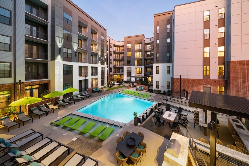 an outdoor pool with lounge chairs and umbrellas at the bradley braddock road at Abberly Foundry Apartment Homes, Nashville, Tennessee