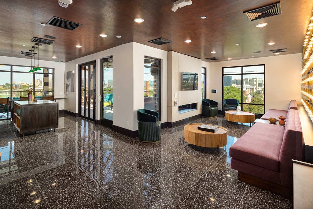 a view of the lobby of the building with a red couch and black and white tile floor at Abberly Foundry Apartment Homes, Nashville
