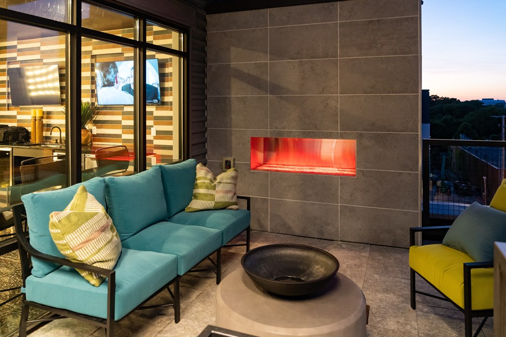 a living room with a blue couch and yellow chairs at Abberly Foundry Apartment Homes, Nashville, TN