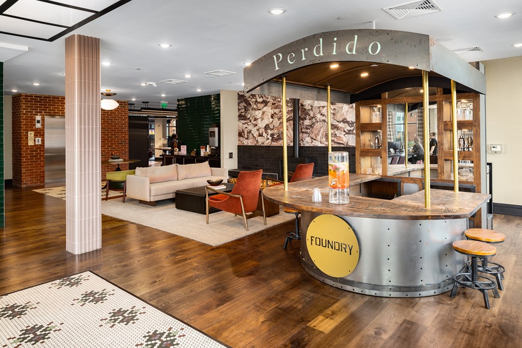 a reception area with a reception desk and couches at Abberly Foundry Apartment Homes, Nashville, TN, 37206