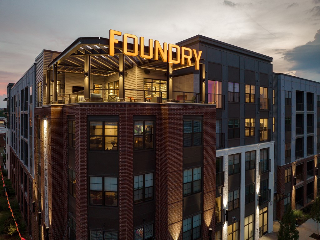 a rendering of the exterior of the foundry building at dusk at Abberly Foundry Apartment Homes, Nashville, TN