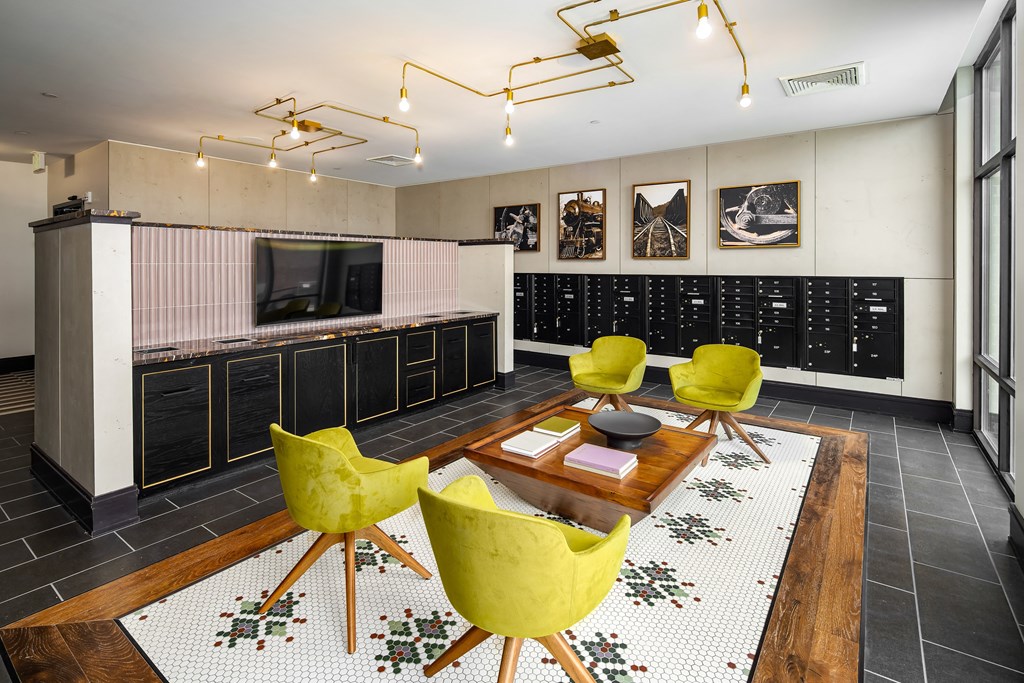 a living room filled with yellow chairs and a wooden tableat Abberly Foundry Apartment Homes, Nashville, TN, 37206