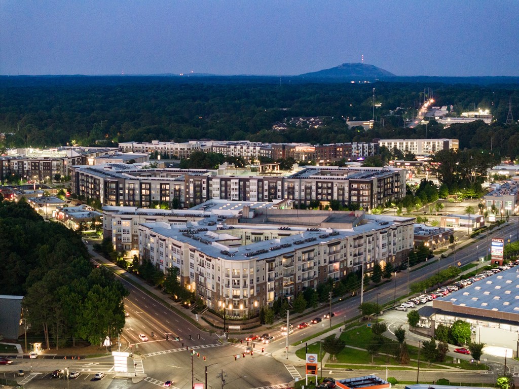 a city at night with a mountain in the background at Abberly Onyx Apartment Homes, Decatur, GA