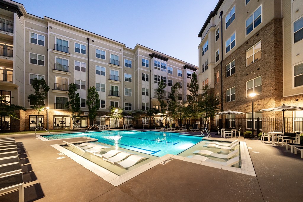 an apartment complex with a swimming pool  at Abberly Onyx Apartment Homes, Georgia, 30033