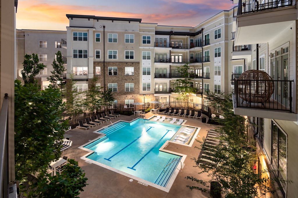 an apartment complex with a swimming pool  at Abberly Onyx Apartment Homes, Georgia